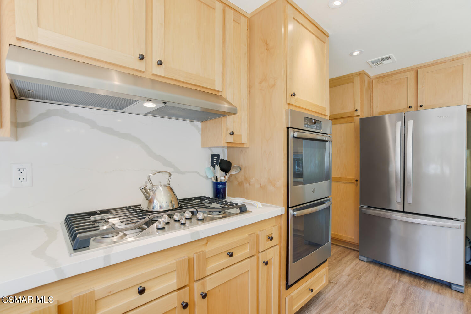 12568 Crystal Ranch Road Moorpark, CA 93021 - Photo 14 of 39 a kitchen with refrigerator a stove and cabinets