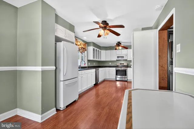 a kitchen with stainless steel appliances white cabinets and a granite counter tops