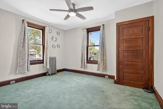 an empty room with windows and closet