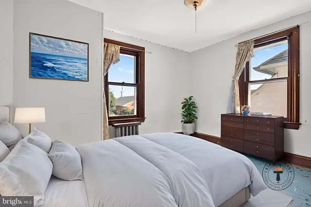 a bedroom with a large bed and a window