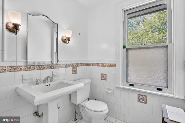 a bedroom with a bed and a potted plant