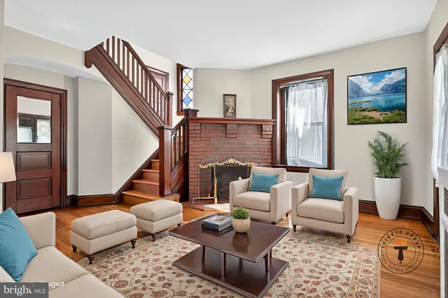 a living room with furniture a flat screen tv and a window