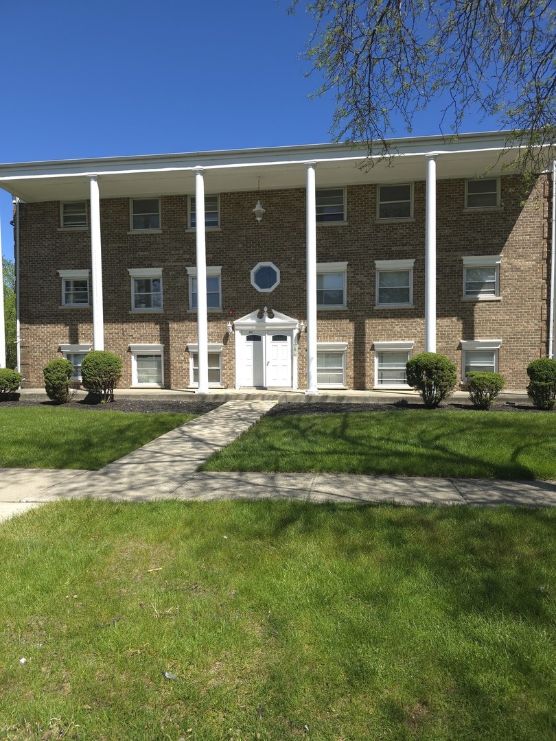 4052 Charleston Road, Unit 3E Matteson, IL 60443 - Photo 1 of 5 a front view of a house with a yard and garage
