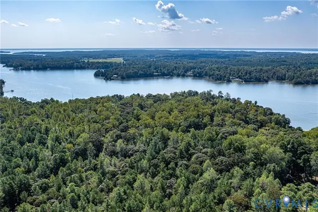 an aerial view of a houses with a lake