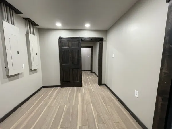 a view of gallery with wooden floor