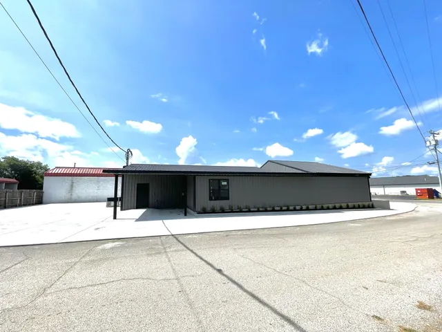 a swimming pool with yard in front of it