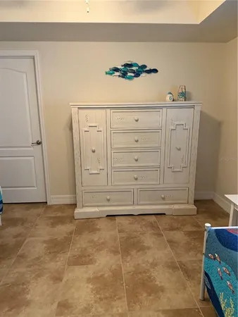 a bedroom with a bed and paintings on the wall