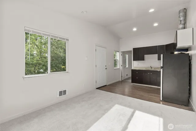 a view of a kitchen with a sink and cabinets
