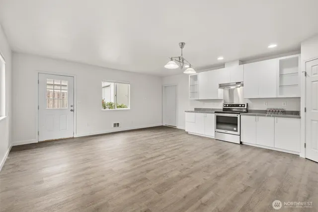 a view of a kitchen with microwave and cabinets