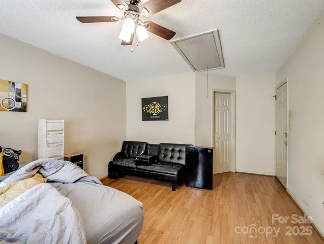 a bedroom with a bed and ceiling fan