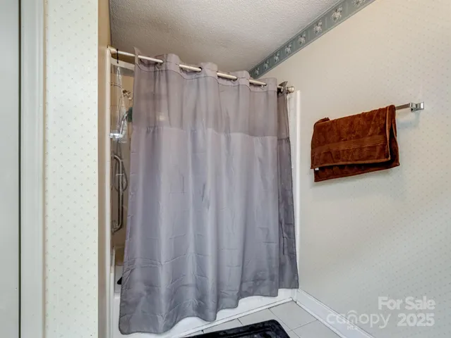 a bathroom with a shower curtain and a shower curtain