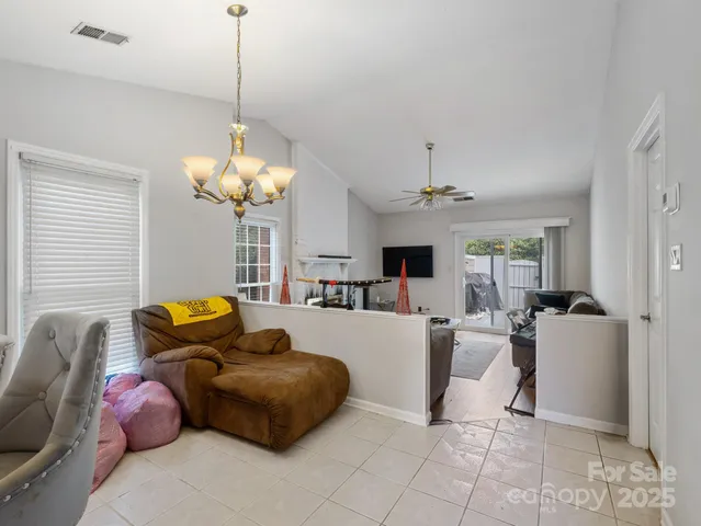 a living room with furniture a chandelier and a chandelier