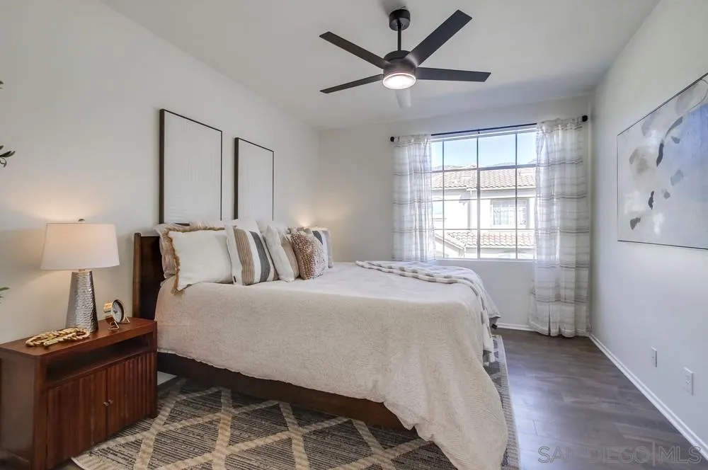 12490 Heatherton Court, Unit 10 San Diego, CA 92128 - Photo 12 of 39 a bedroom with a bed and wooden floor