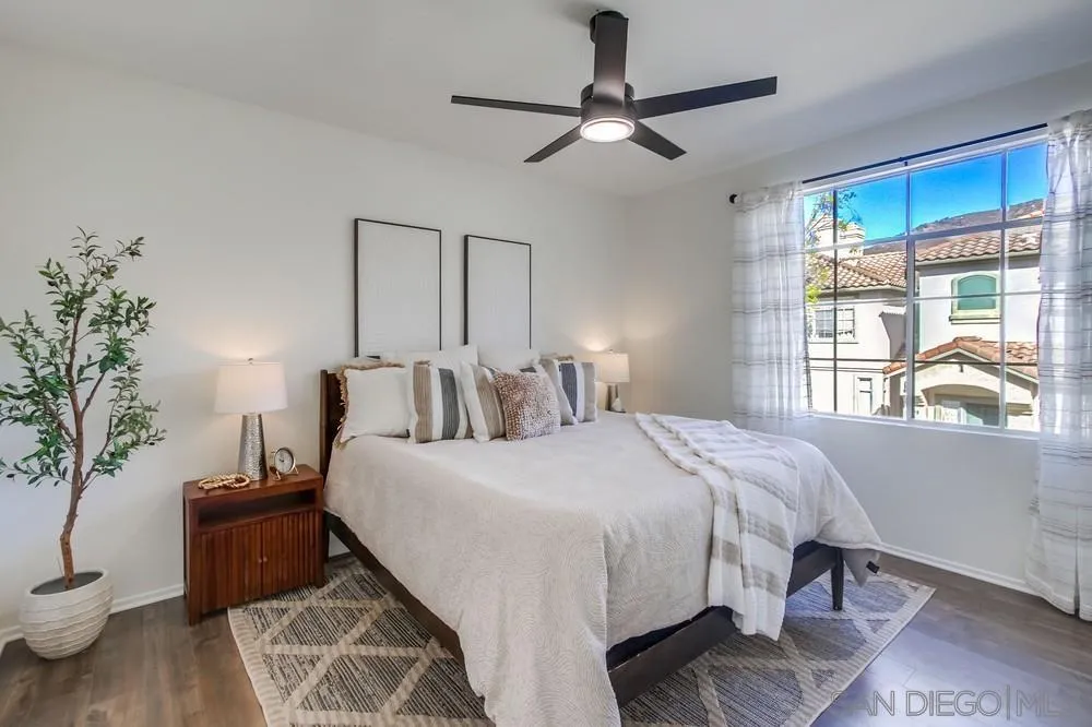12490 Heatherton Court, Unit 10 San Diego, CA 92128 - Photo 14 of 39 a bedroom with bed and a large window