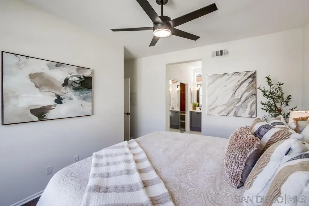 12490 Heatherton Court, Unit 10 San Diego, CA 92128 - Photo 15 of 39 a bedroom with a large bed and a painting on the wall