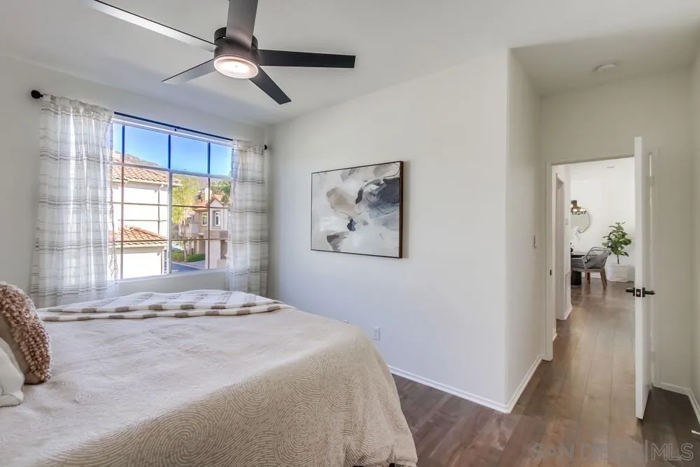 12490 Heatherton Court, Unit 10 San Diego, CA 92128 - Photo 16 of 39 a bedroom with a large bed and a window
