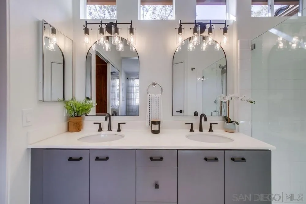 12490 Heatherton Court, Unit 10 San Diego, CA 92128 - Photo 18 of 39 a bathroom with double vanity sinks and a mirror