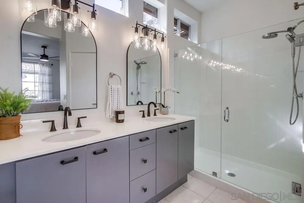 12490 Heatherton Court, Unit 10 San Diego, CA 92128 - Photo 19 of 39 a bathroom with a double vanity sink mirror and shower