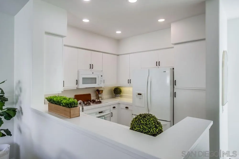 12490 Heatherton Court, Unit 10 San Diego, CA 92128 - Photo 22 of 39 a bathroom with a granite countertop sink and a mirror