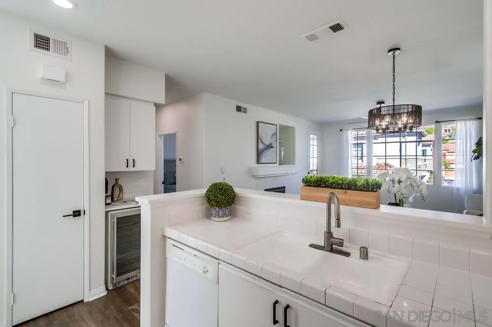 12490 Heatherton Court, Unit 10 San Diego, CA 92128 - Photo 25 of 39 a kitchen with kitchen island a counter top space appliances and cabinets