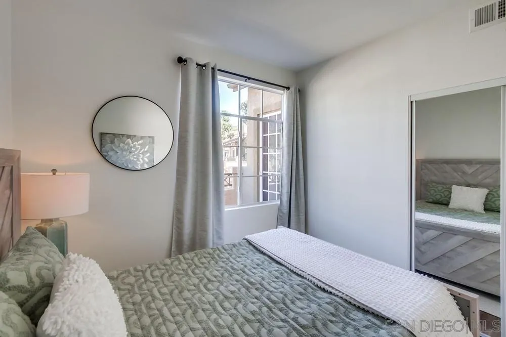 12490 Heatherton Court, Unit 10 San Diego, CA 92128 - Photo 27 of 39 a bedroom with a large bed and a window