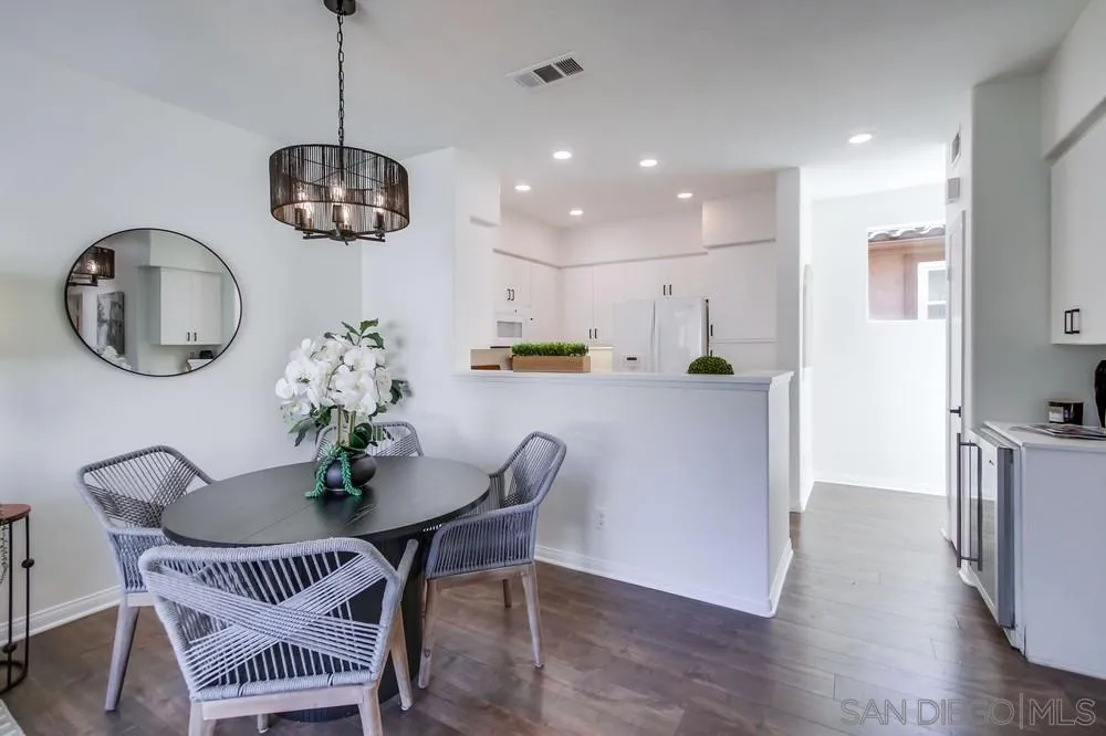 12490 Heatherton Court, Unit 10 San Diego, CA 92128 - Photo 10 of 39 a view of a dining room with furniture wooden floor and chandelier