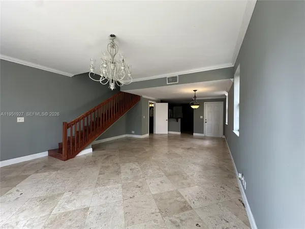 a view of a hallway with a chandelier