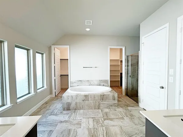 a bedroom with a large bed and a large window