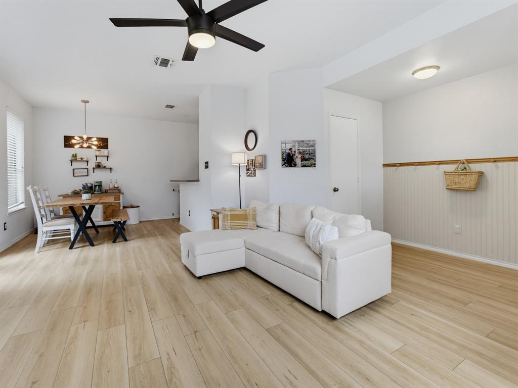 600 Stirling Road Rhome, TX 76078 - Photo 9 of 38 Expansive open-concept room featuring light wood-finish flooring, recessed lighting, and a modern ceiling fan