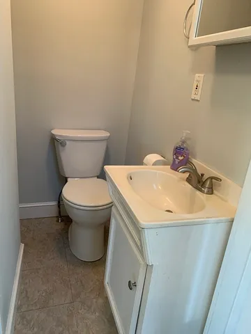 an empty room with a chandelier fan