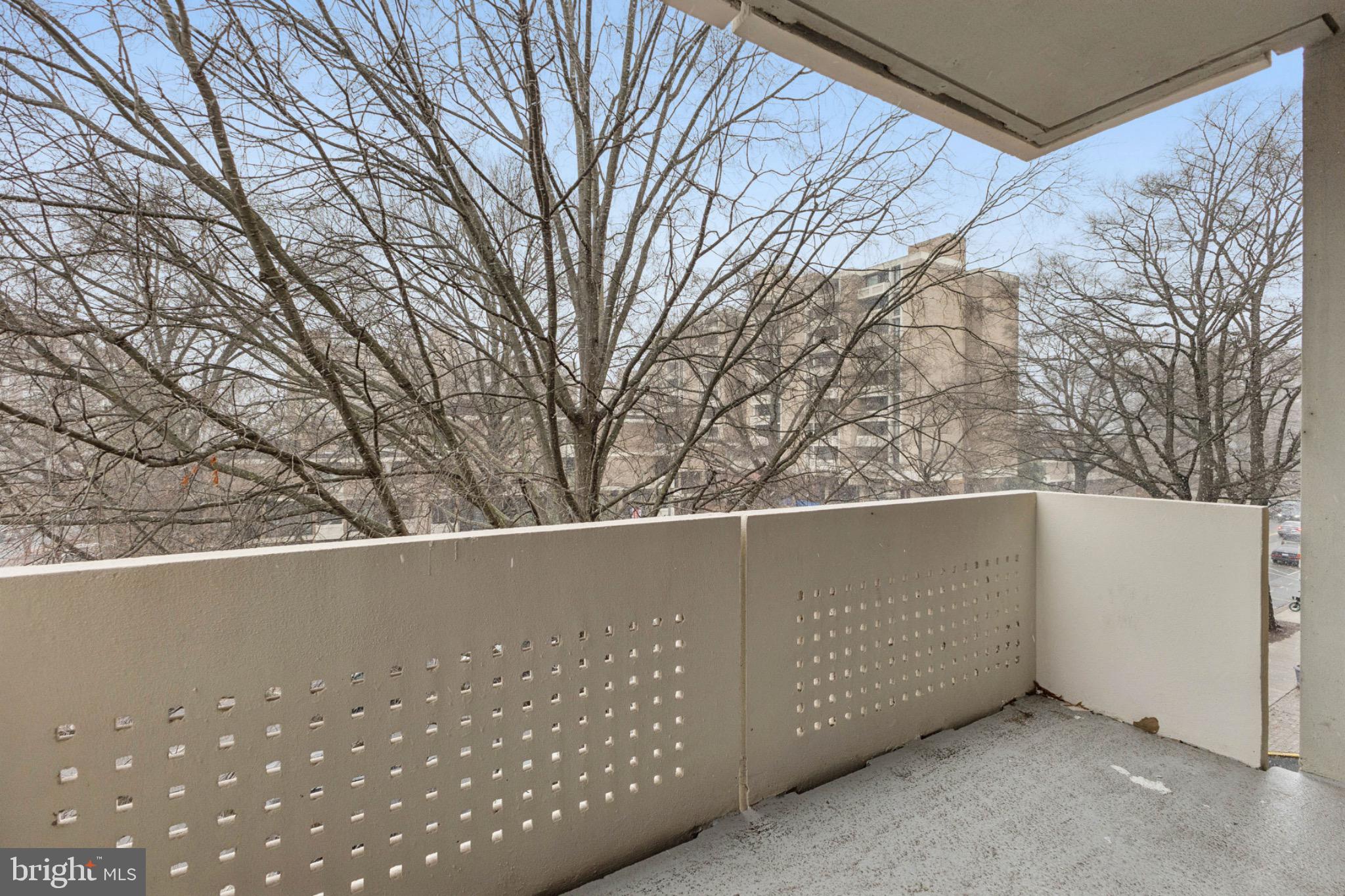 1250 4th Street Southwest, Unit W214 Washington, DC 20024 - Photo 15 of 29 Serene balcony with urban tree views.