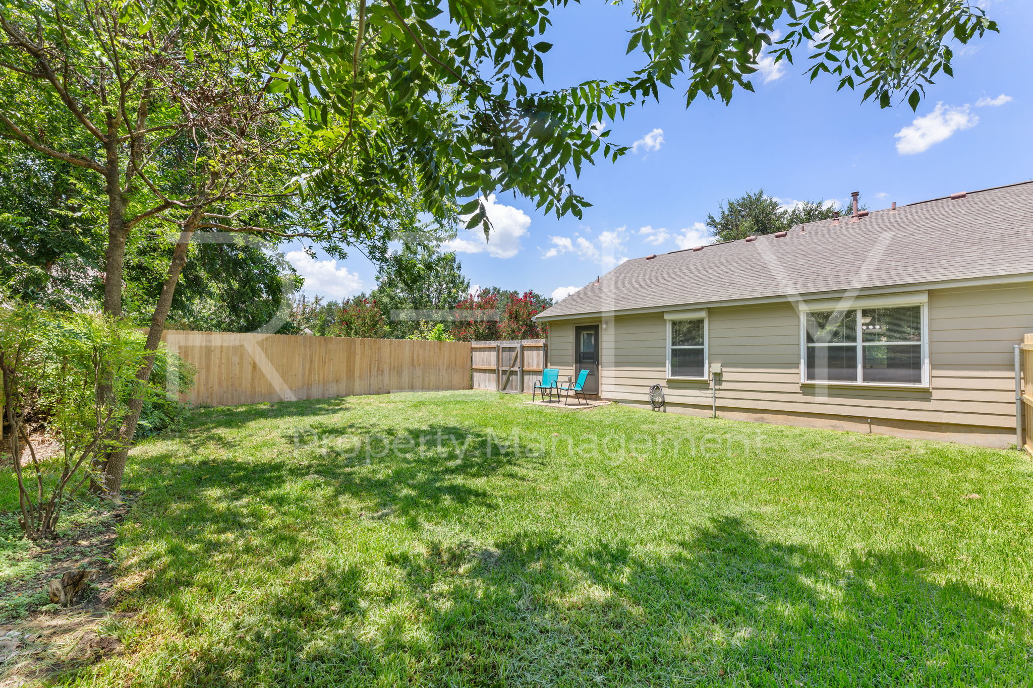 103 Prairie Springs Loop Georgetown, TX 78626 - Photo 31 of 33 A generous, fenced backyard offers private outdoor living space.