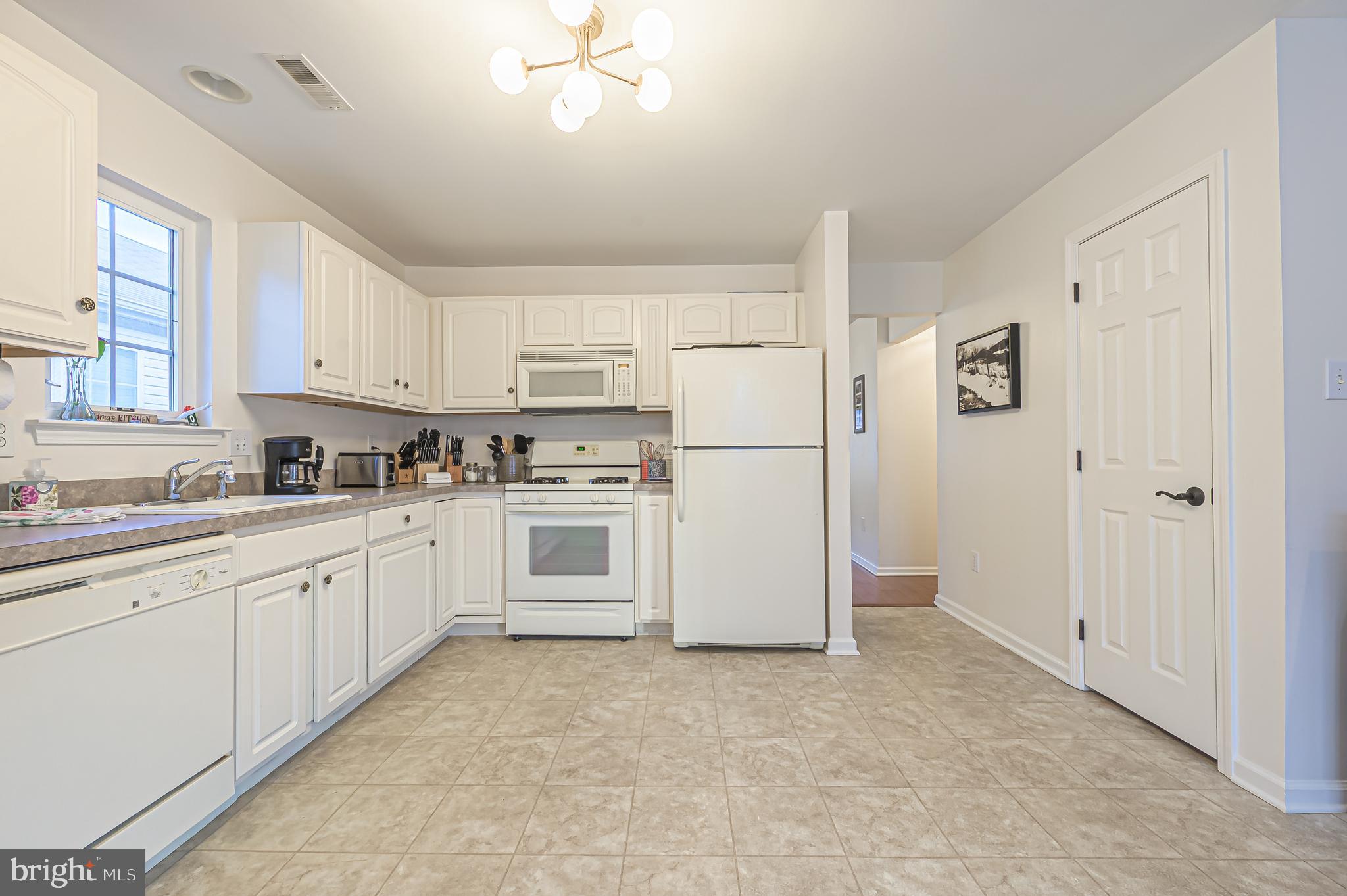19 Gasko Road Mays Landing, NJ 08330 - Photo 19 of 31 a kitchen with white cabinets and white appliances