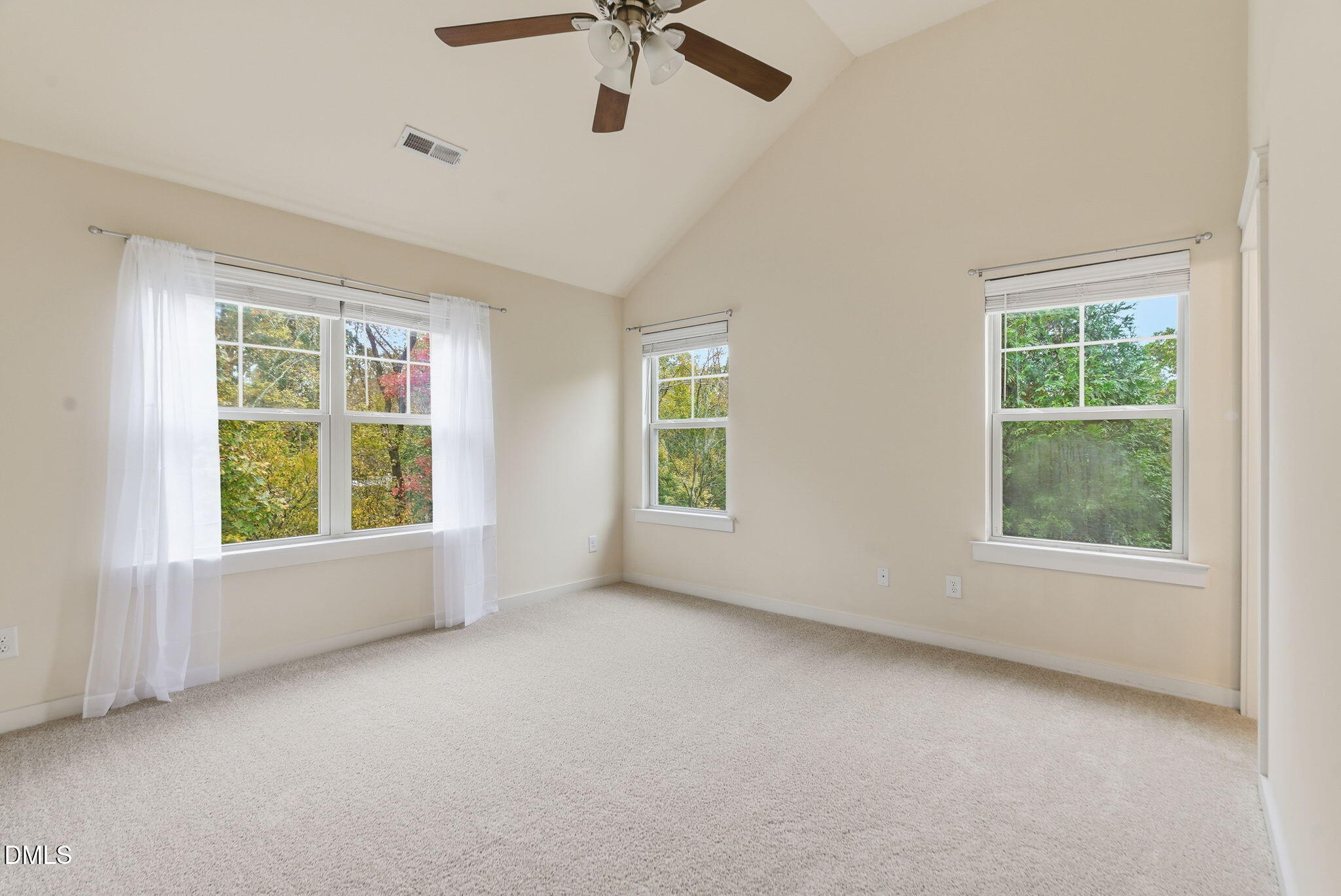 7851 Allscott Way Raleigh, NC 27612 - Photo 44 of 74 an empty room with a window and a ceiling fan