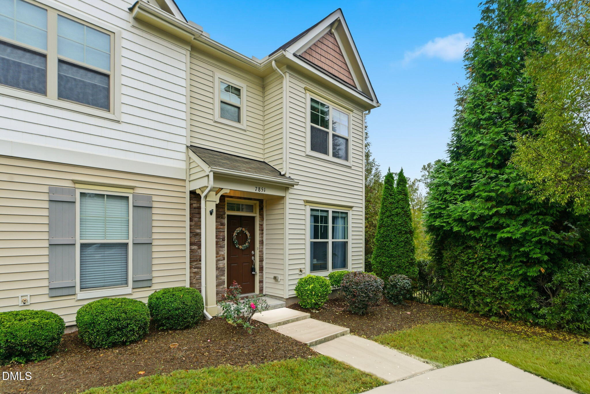 7851 Allscott Way Raleigh, NC 27612 - Photo 59 of 74 a view of a house with brick walls and a yard with plants