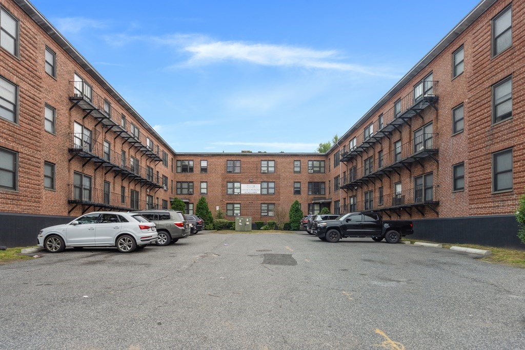 11 Victory Road, Unit 27 Boston, MA 02122 - Photo 14 of 16 a buildings with car parked in front of it