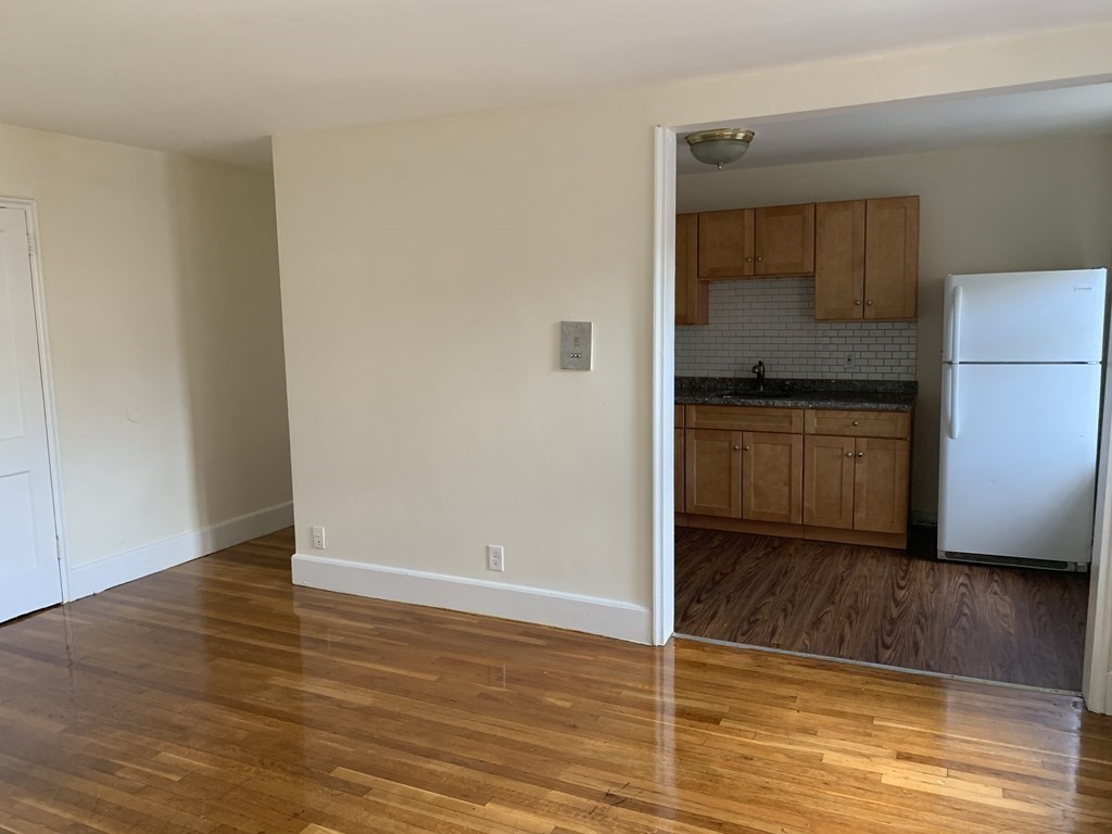 11 Victory Road, Unit 27 Boston, MA 02122 - Photo 2 of 16 a view of a kitchen cabinets and wooden floor