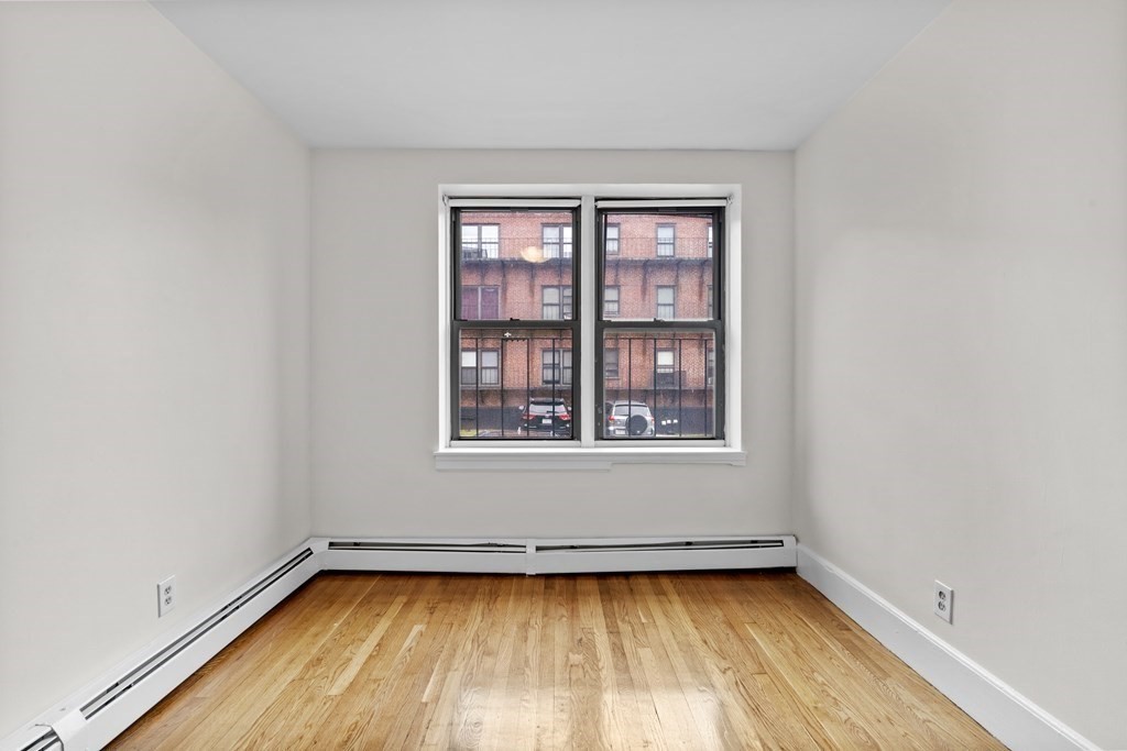 11 Victory Road, Unit 27 Boston, MA 02122 - Photo 8 of 16 a view of a room with wooden floor and window