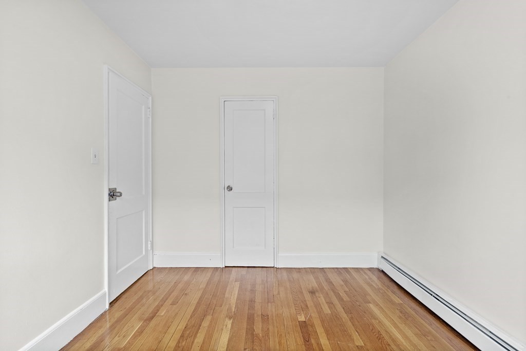 11 Victory Road, Unit 27 Boston, MA 02122 - Photo 10 of 16 a view of an empty room with wooden floor