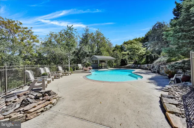 a swimming pool with outdoor seating and garden
