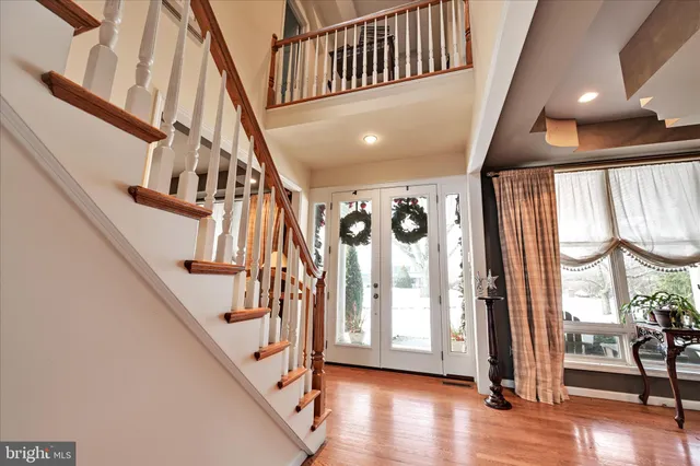a kitchen with stainless steel appliances granite countertop a stove a sink and white cabinets