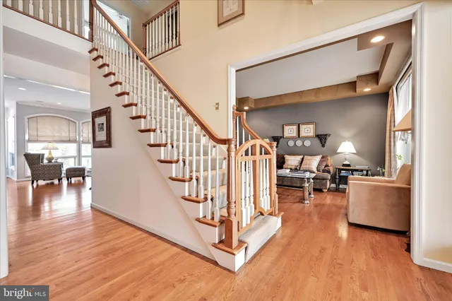 a large kitchen with kitchen island a dining table chairs and a wooden floor