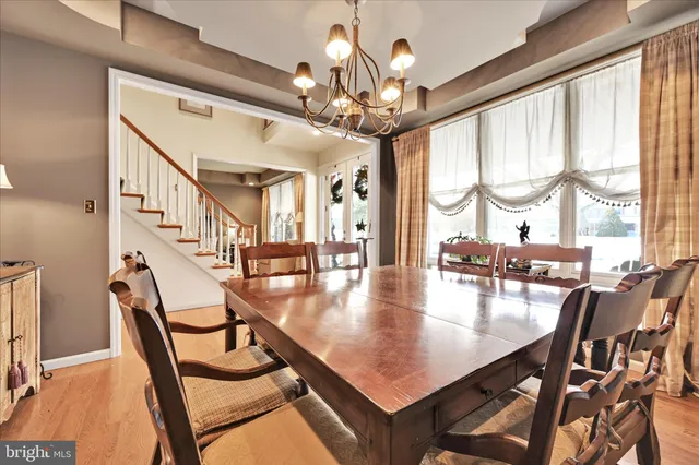 a bedroom with a bed and a dresser with wooden floor