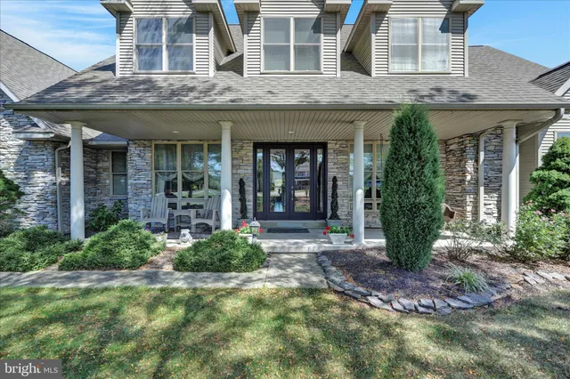 an aerial view of a house with a swimming pool a yard and a garden
