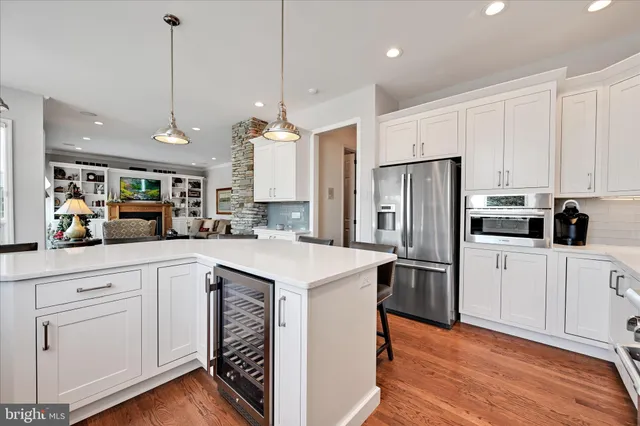 a spacious bathroom with double vanity a mirror and a bathtub