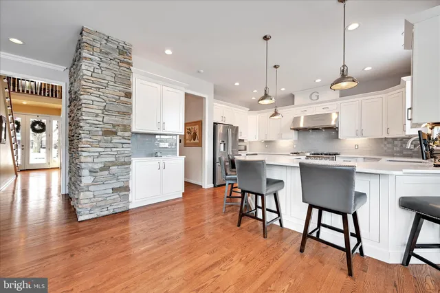 a spacious bathroom with a double vanity sink a mirror and a shower