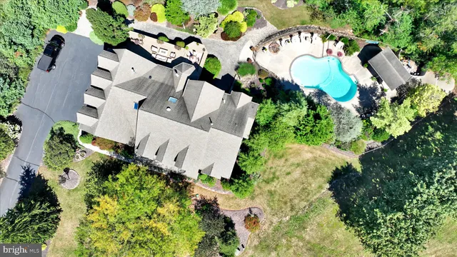 an aerial view of a house with a swimming pool yard and outdoor seating