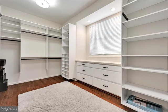 a living room with furniture ceiling fan and a rug