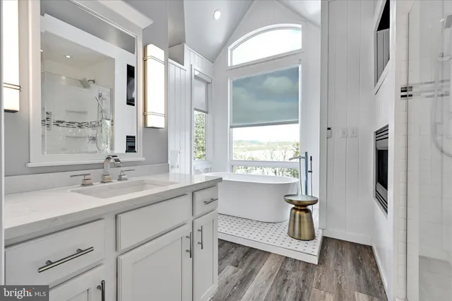 a living room with furniture a flat screen tv and a large window