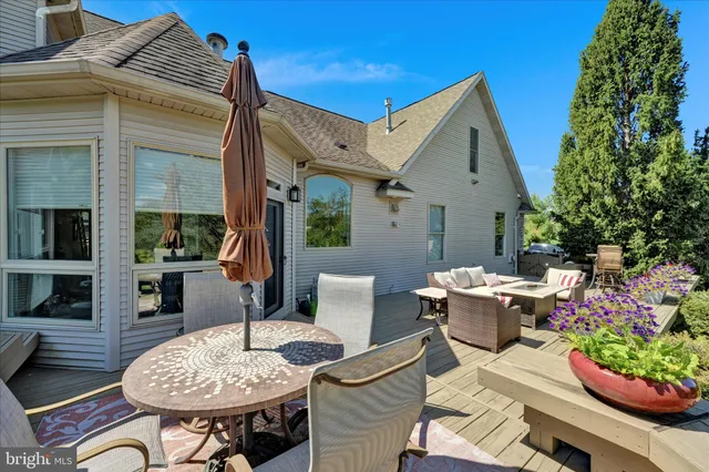 a view of a patio with a table chairs and a yard